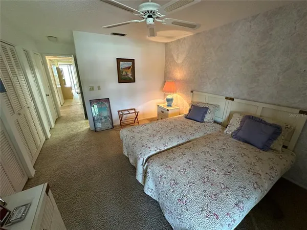 a bedroom with a bed a couch and dresser