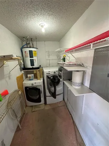 a utility room with sink dryer and washer