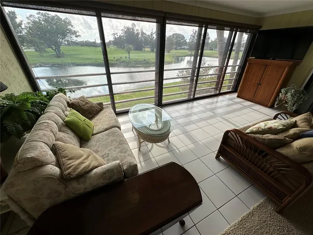 a bedroom with furniture and a large window