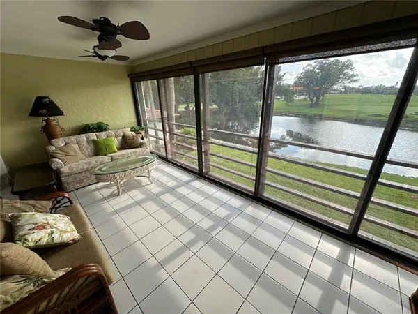 a living room with furniture and a floor to ceiling window