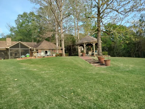 a view of a house with backyard porch and sitting area