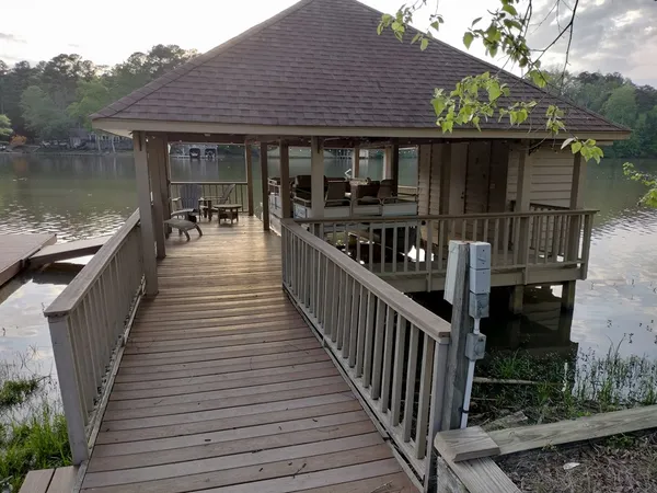 a view of a house with backyard and deck
