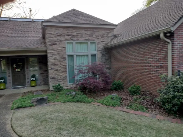a front view of a house with garden