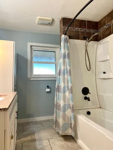 a bathroom with a bathtub and shower