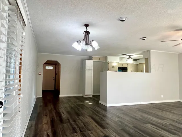 a view of a room with wooden floor