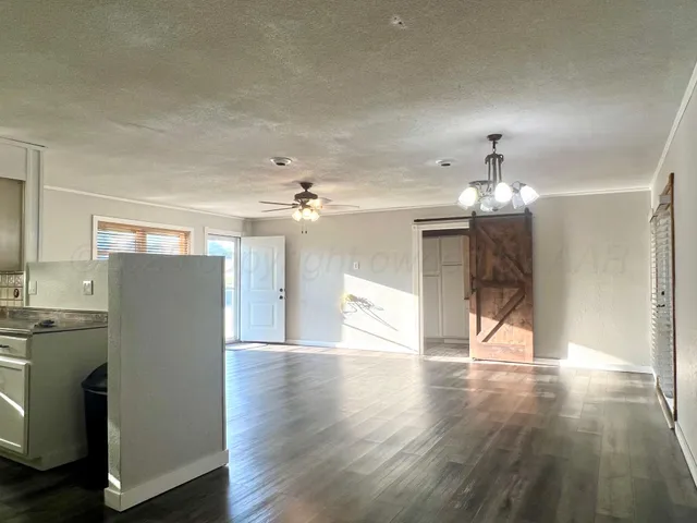 a view of a livingroom with a furniture wooden floor and chandelier