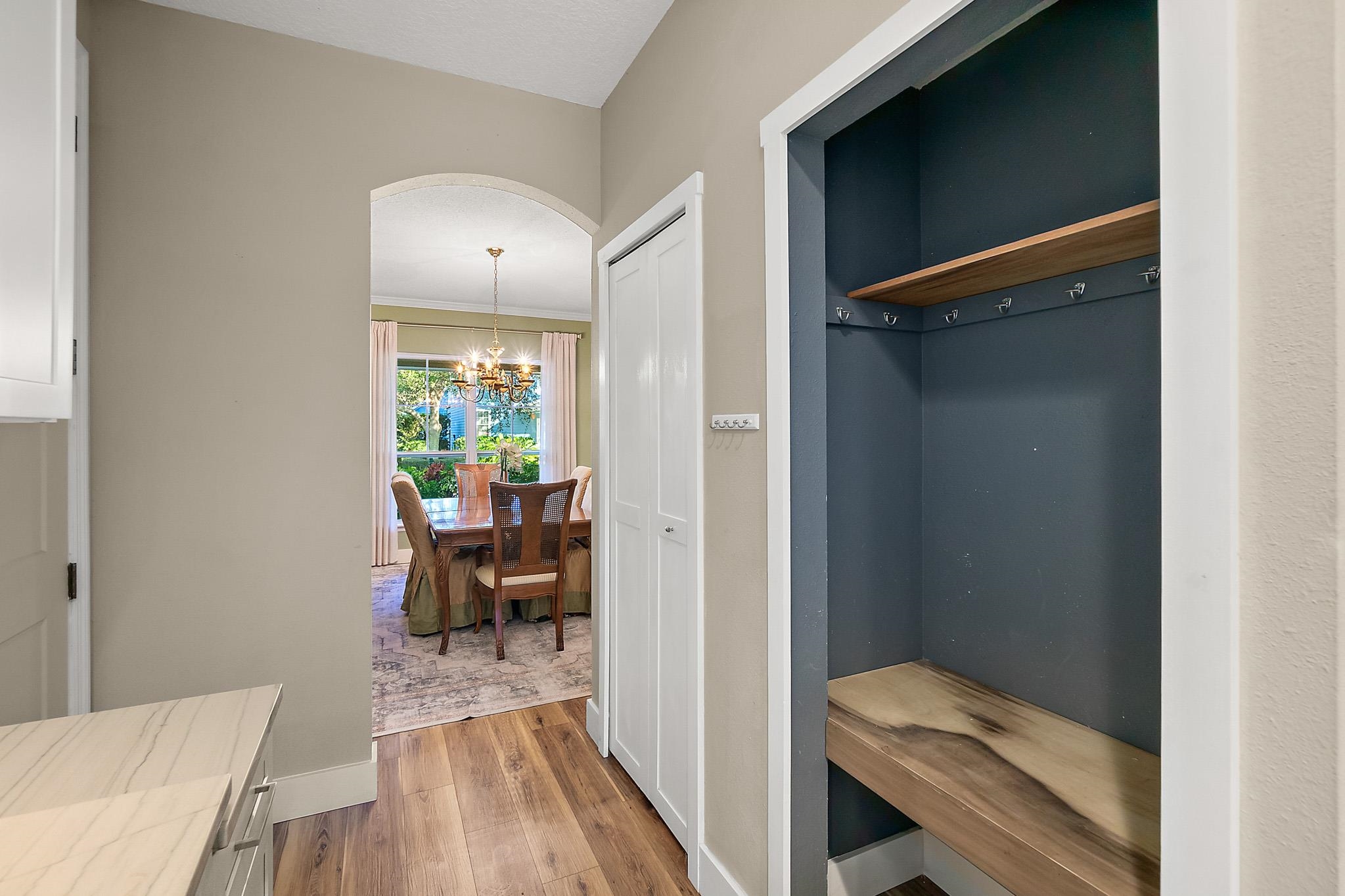 915 Saltwater Circle St. Augustine, FL 32080 - Photo 14 of 60 Mudroom with arched walkways, a chandelier, and wood finished floors