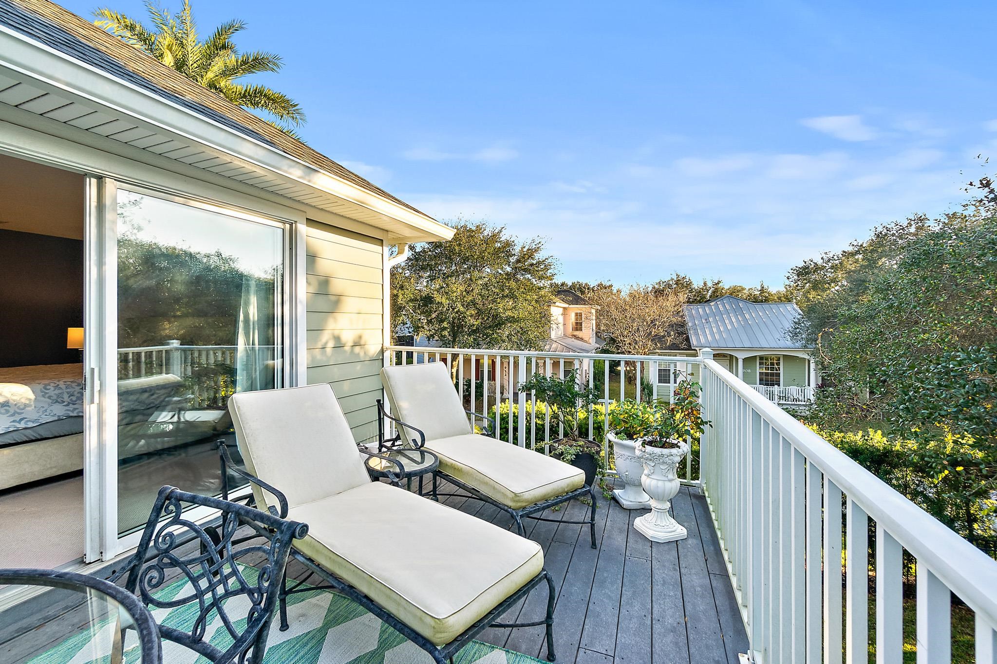 915 Saltwater Circle St. Augustine, FL 32080 - Photo 24 of 60 a view of a balcony with wooden floor and outdoor seating
