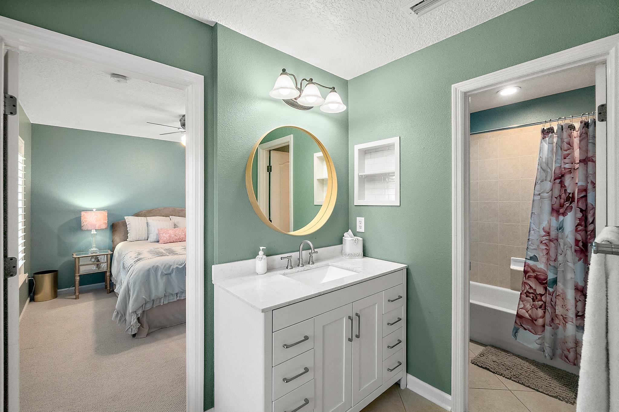 915 Saltwater Circle St. Augustine, FL 32080 - Photo 36 of 60 a en suite bathroom with a double vanity sink and a mirror