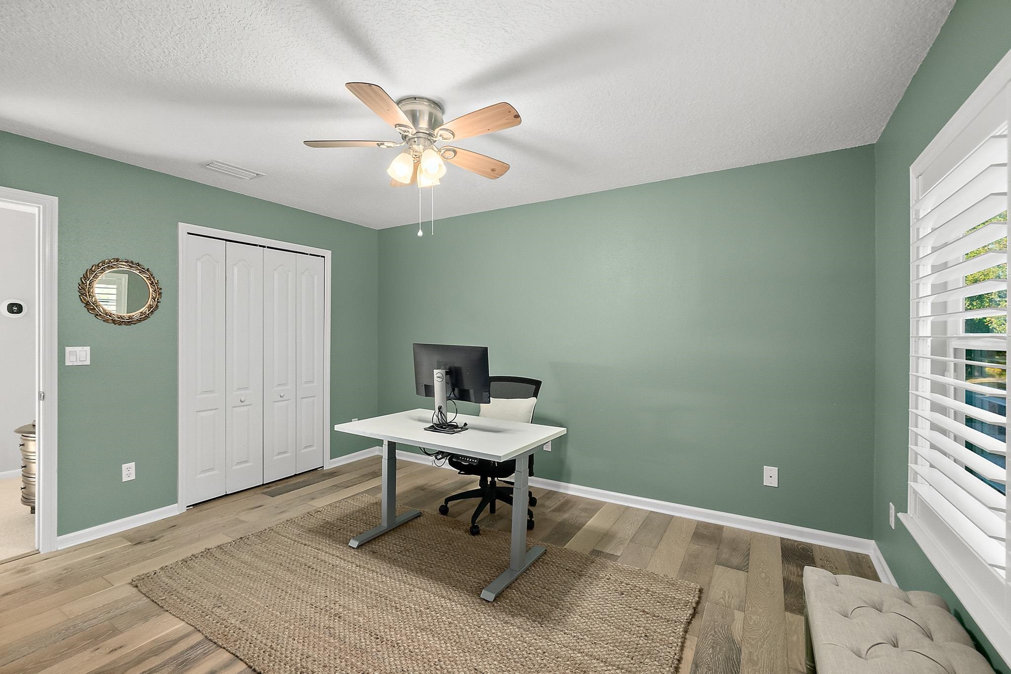 915 Saltwater Circle St. Augustine, FL 32080 - Photo 37 of 60 a workspace with chandelier fan and a window