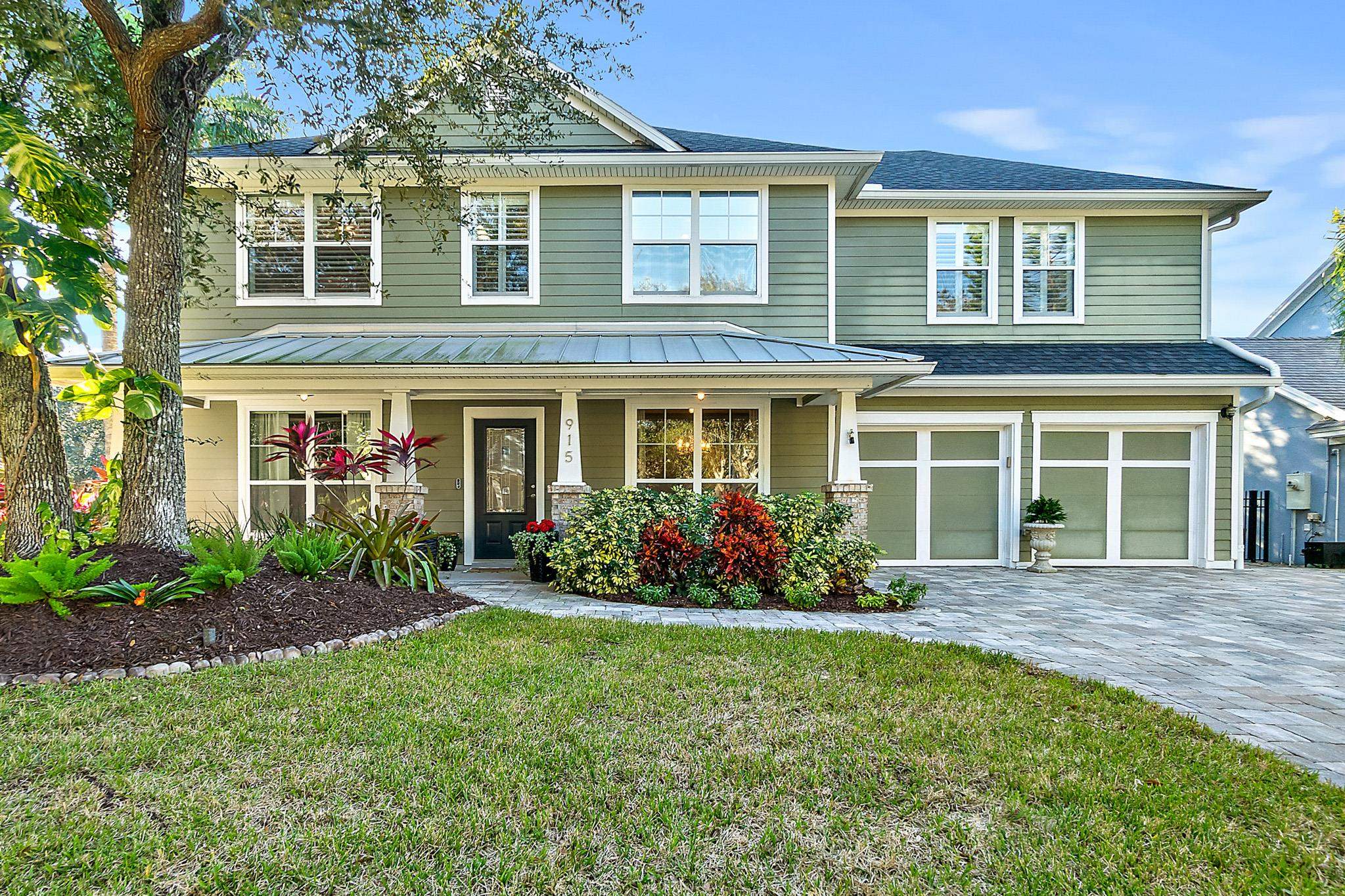 915 Saltwater Circle St. Augustine, FL 32080 - Photo 46 of 60 View of front of property with a front yard, covered porch, decorative driveway, an attached garage, and a shingled roof