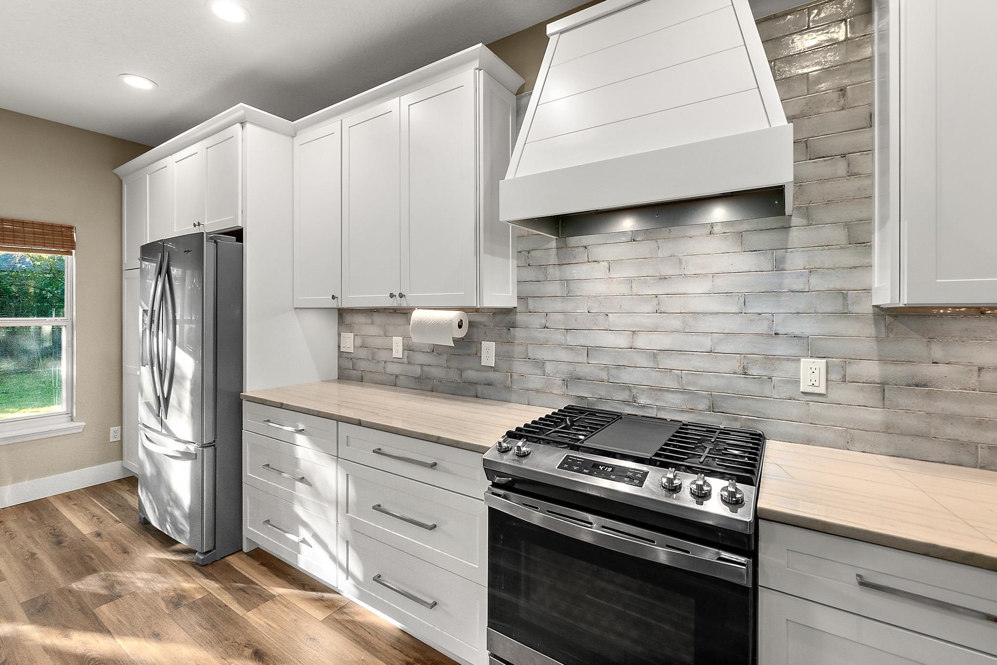 915 Saltwater Circle St. Augustine, FL 32080 - Photo 8 of 60 a kitchen with stainless steel appliances granite countertop a stove a refrigerator and a microwave