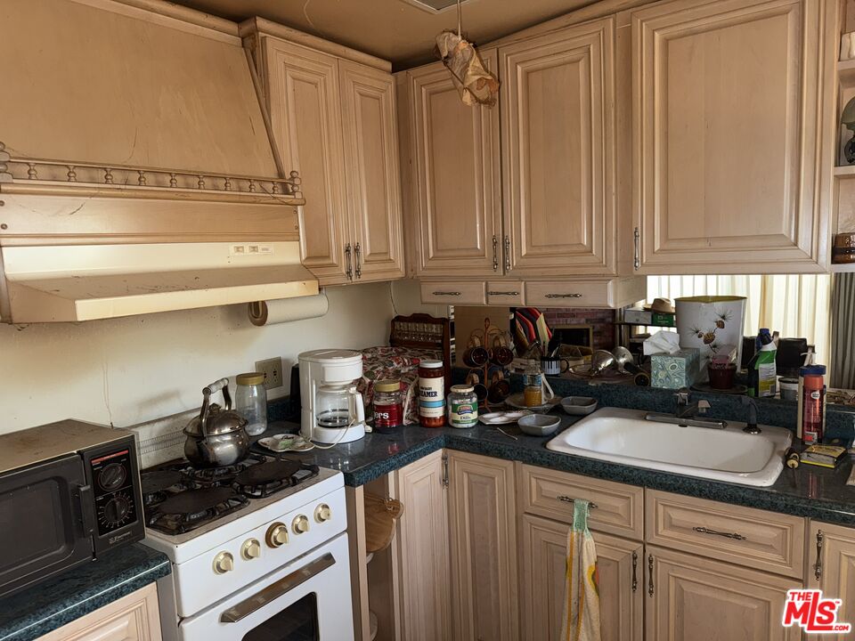 21801 Plunge Road Cedarpines Park, CA 92322 - Photo 4 of 6 a kitchen with a stove a sink and cabinets
