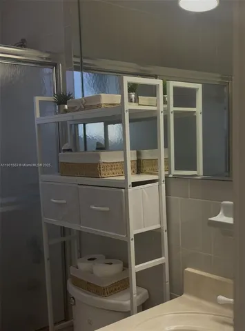 a kitchen with granite countertop white cabinets and stainless steel appliances
