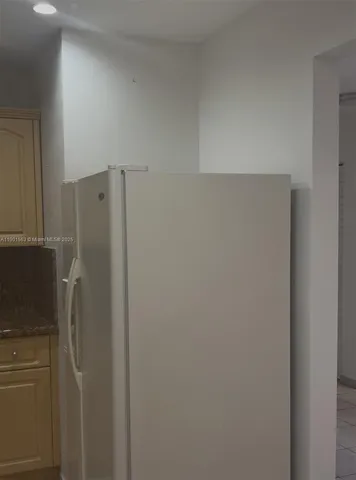 a white refrigerator freezer sitting inside of a kitchen