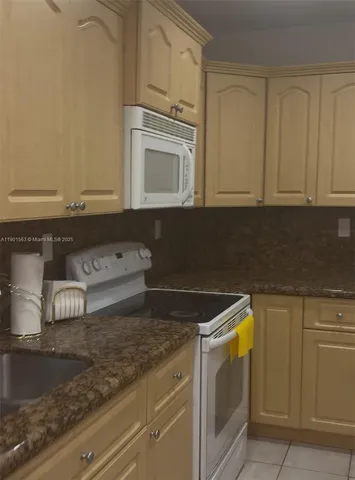 a view of a kitchen with microwave and cabinets