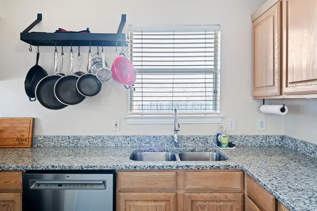 a kitchen with stainless steel appliances granite countertop a sink and a granite counter tops