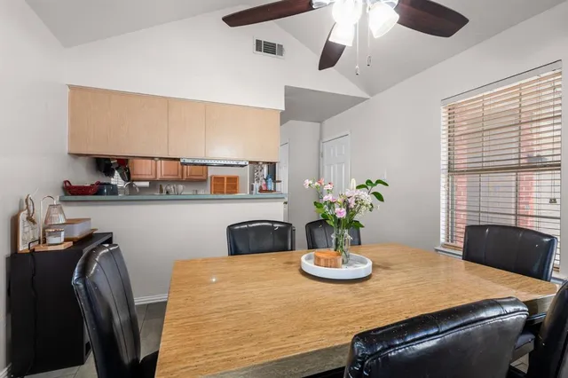 a view of a dining room with furniture and chandelier