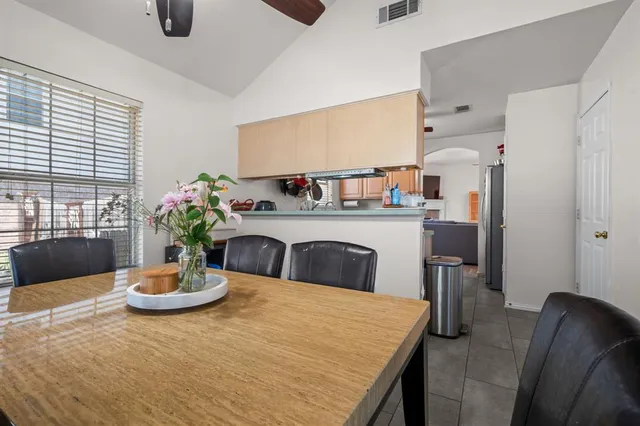 a kitchen with a table and chairs