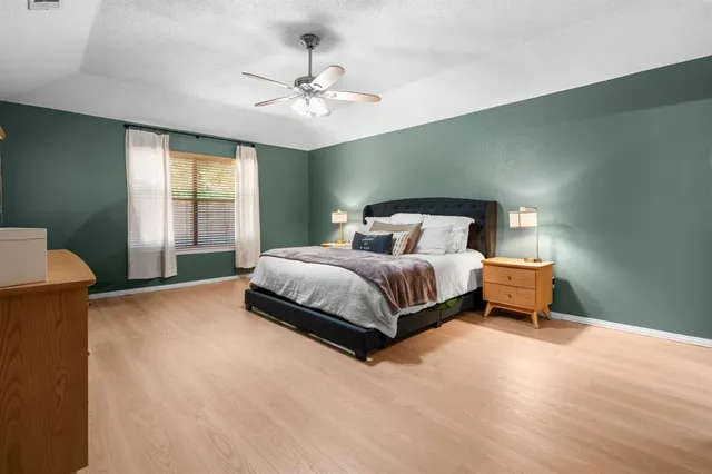 a bedroom with a bed and window