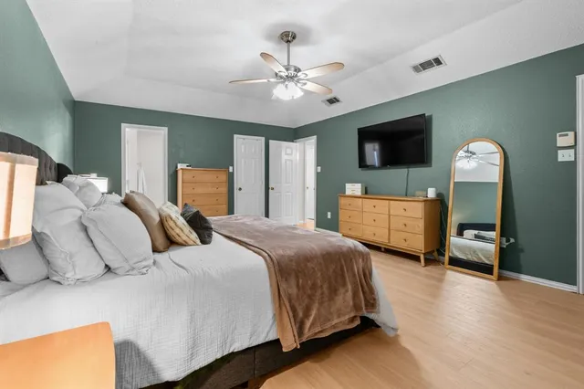 a bedroom with a bed and a flat screen tv