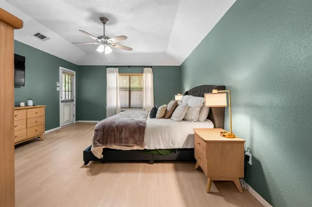 a spacious bedroom with a bed and window