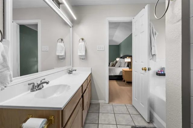 a en suite bathroom with a sink double vanity and a mirror