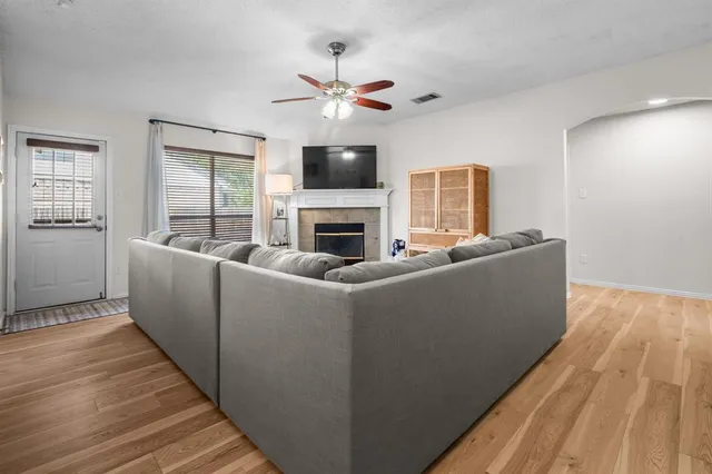 a living room with furniture and a fireplace