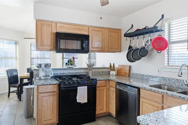 a kitchen with a sink stove and microwave