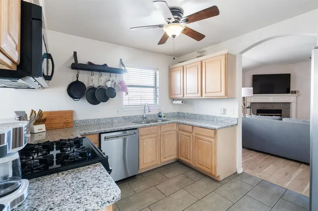 a kitchen with a stove a sink and a microwave