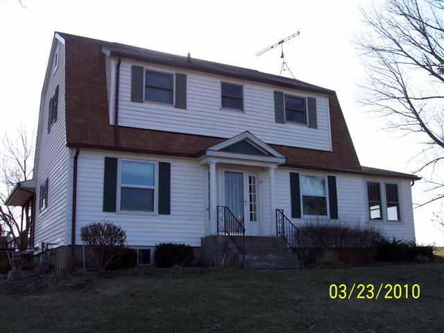 6697 North Lake Road Lena, IL 61048 - Photo 1 of 9 a front view of a house with a garden