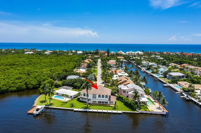 an aerial view of residential houses with outdoor space and swimming pool
