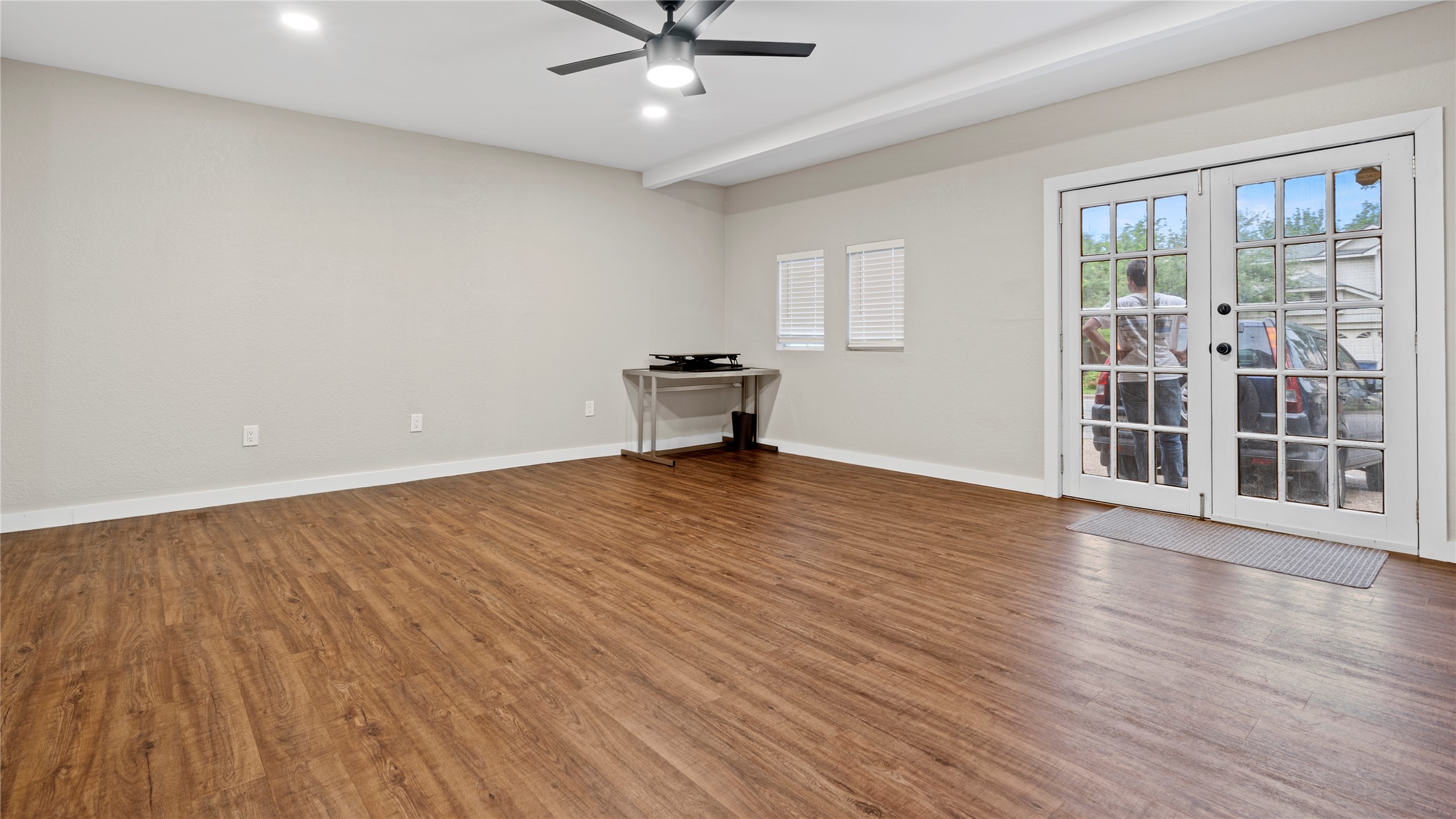 3108 Linnet Drive Austin, TX 78745 - Photo 12 of 24 Unfurnished living room with dark wood-style floors, ceiling fan, french doors, and recessed lighting