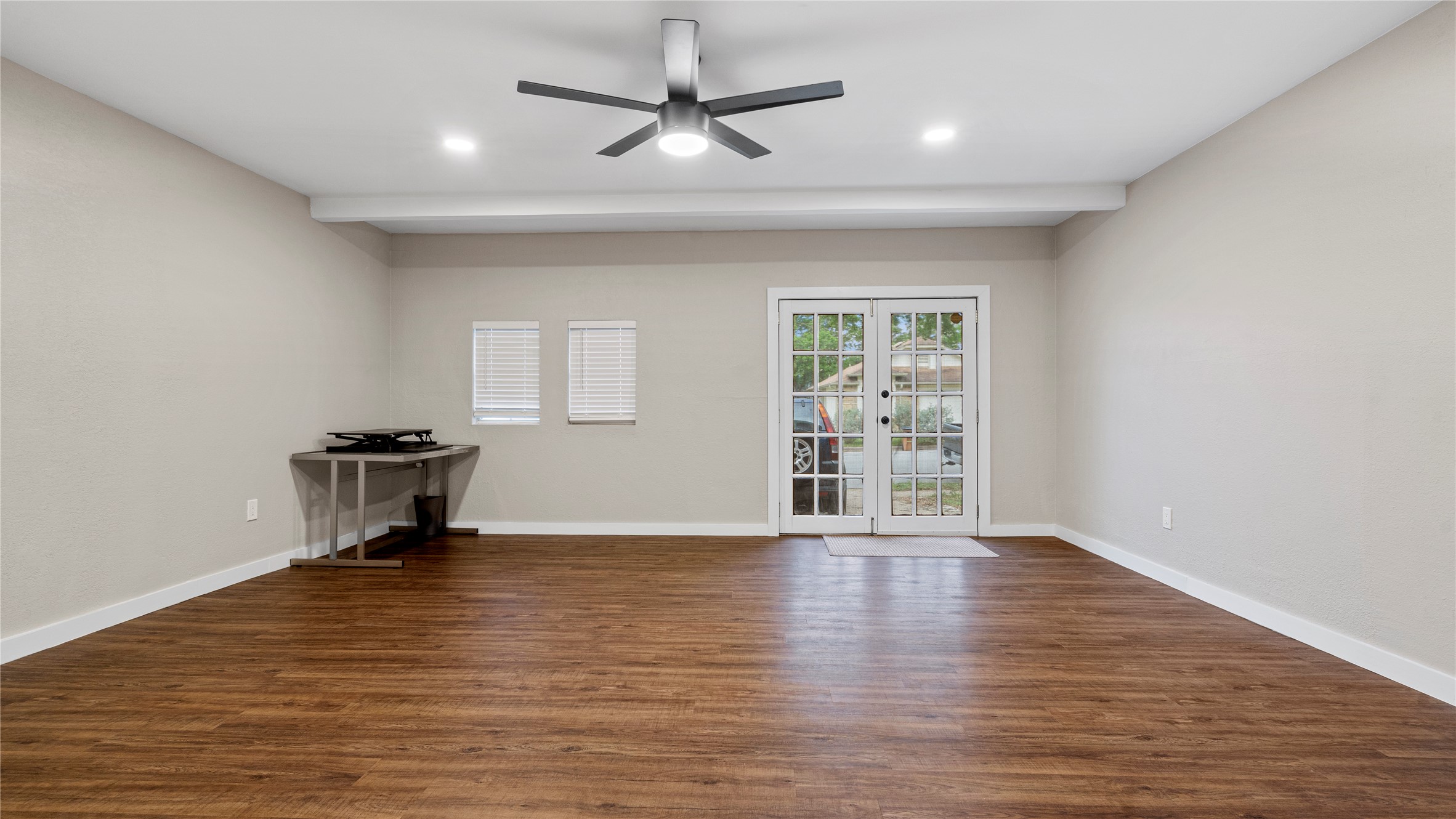3108 Linnet Drive Austin, TX 78745 - Photo 13 of 24 Unfurnished room featuring french doors, a ceiling fan, dark wood finished floors, and recessed lighting