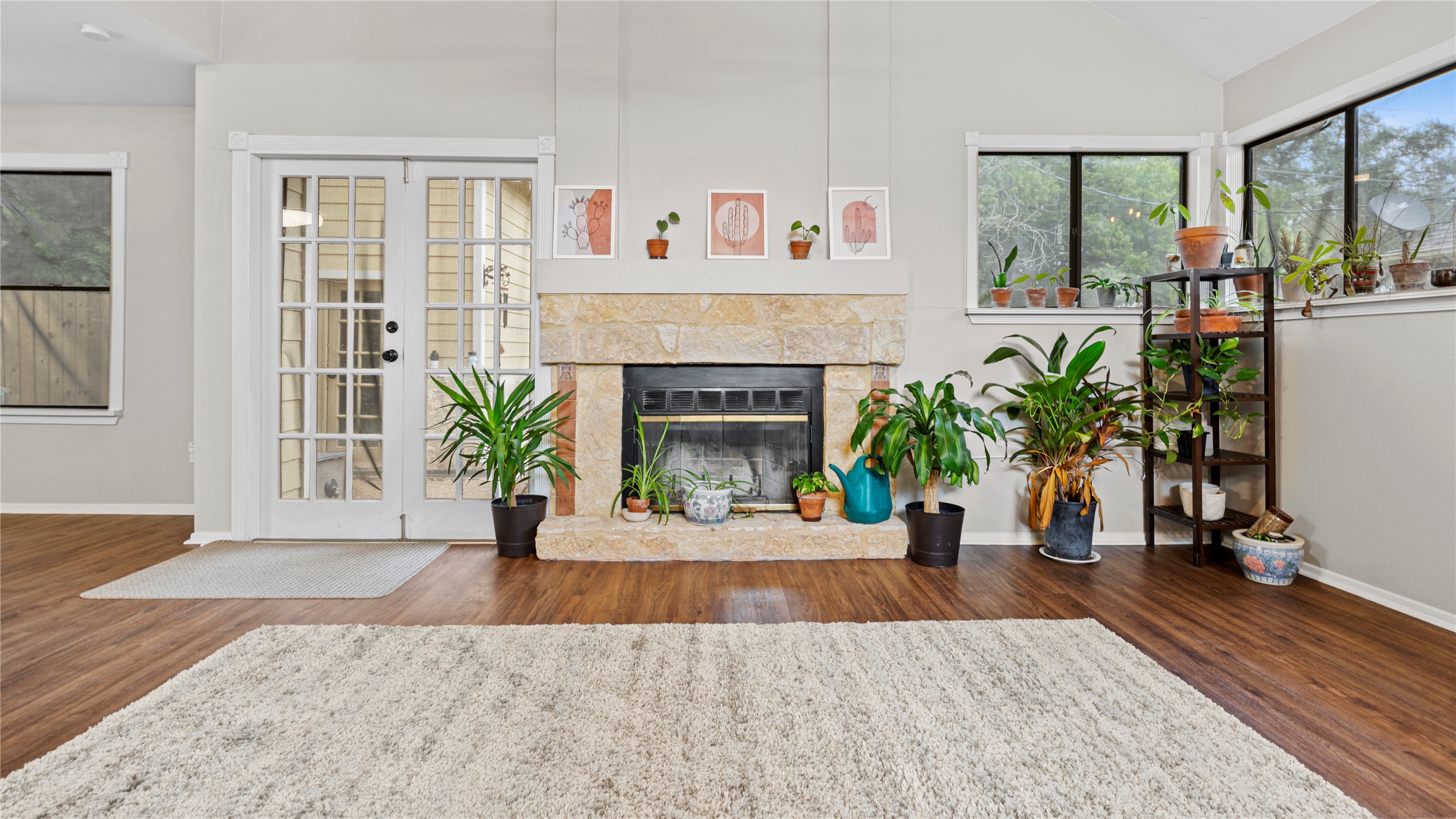 3108 Linnet Drive Austin, TX 78745 - Photo 18 of 24 Living room with wood finished floors, a glass covered fireplace, and lofted ceiling