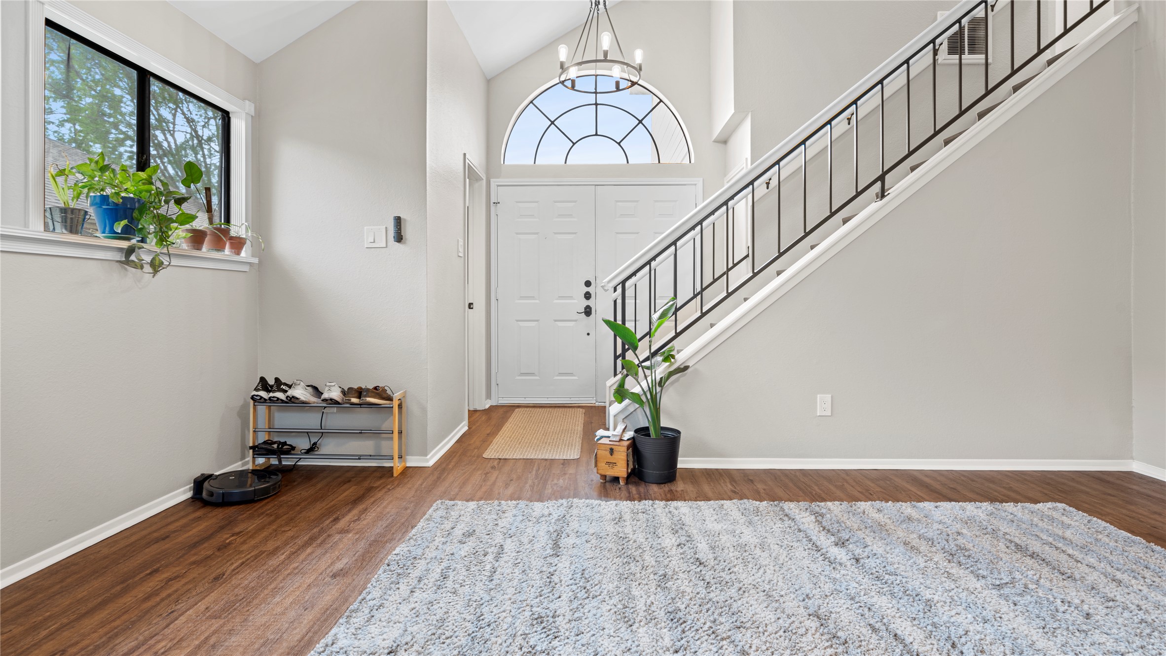 3108 Linnet Drive Austin, TX 78745 - Photo 19 of 24 Entryway featuring lofted ceiling, dark wood-style flooring, and hanging lights