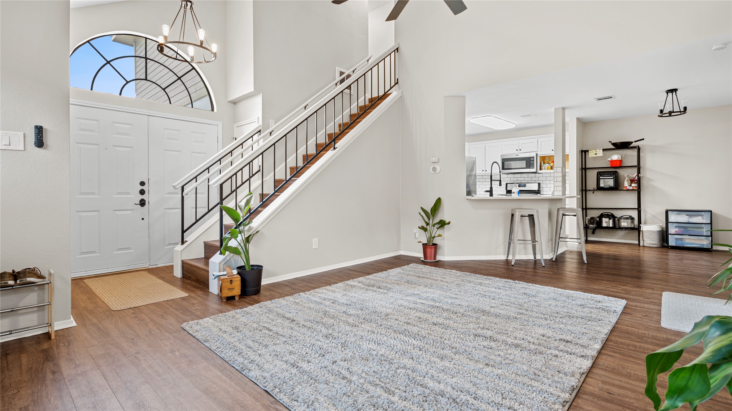 3108 Linnet Drive Austin, TX 78745 - Photo 21 of 24 Entrance foyer featuring dark wood-type flooring, a chandelier, a high ceiling, and ceiling fan