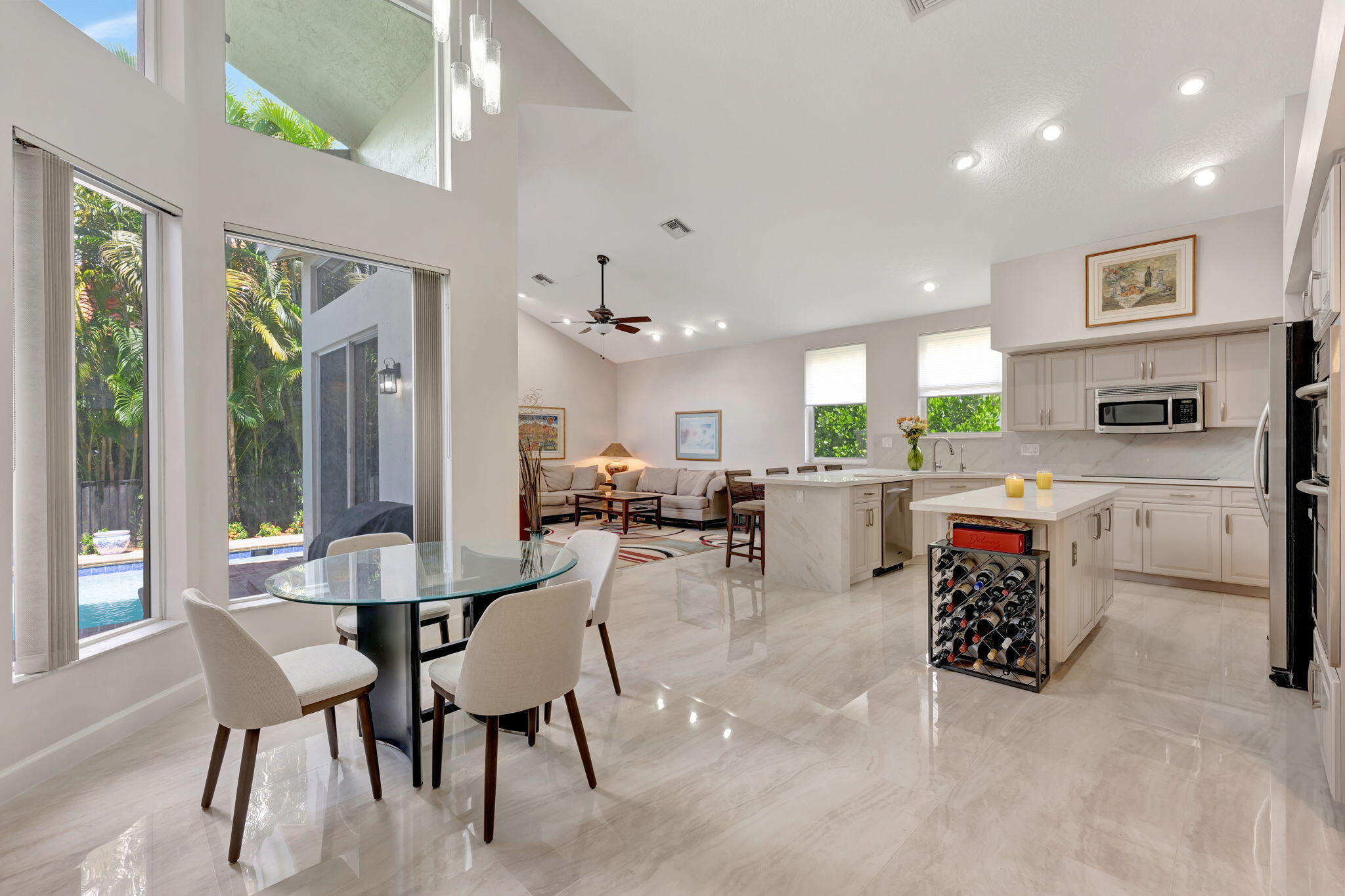 6039 Northwest 31st Terrace Boca Raton, FL 33496 - Photo 18 of 70 a large kitchen with a table and chairs
