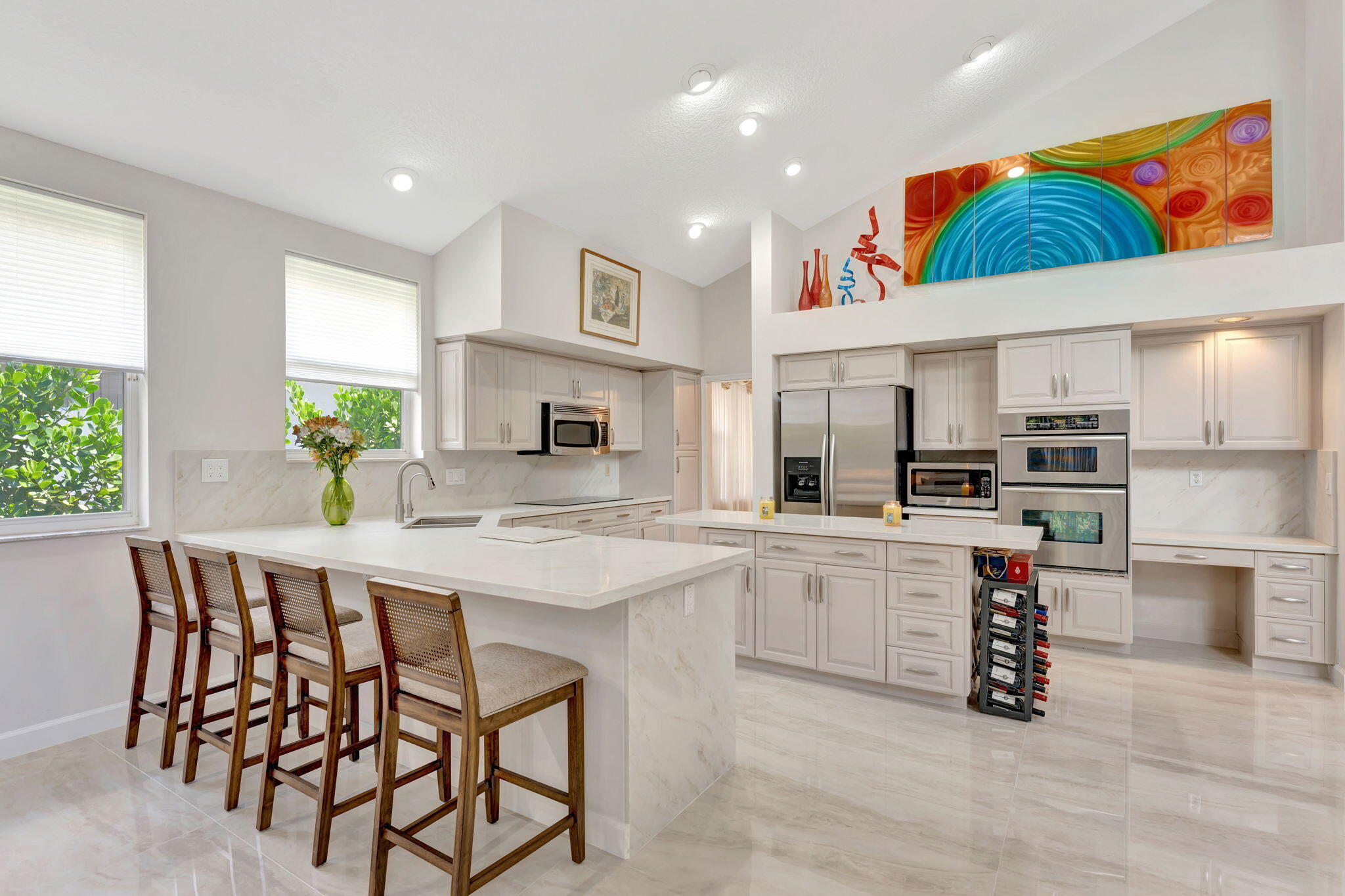 6039 Northwest 31st Terrace Boca Raton, FL 33496 - Photo 20 of 70 a kitchen with stainless steel appliances a table and chairs in it