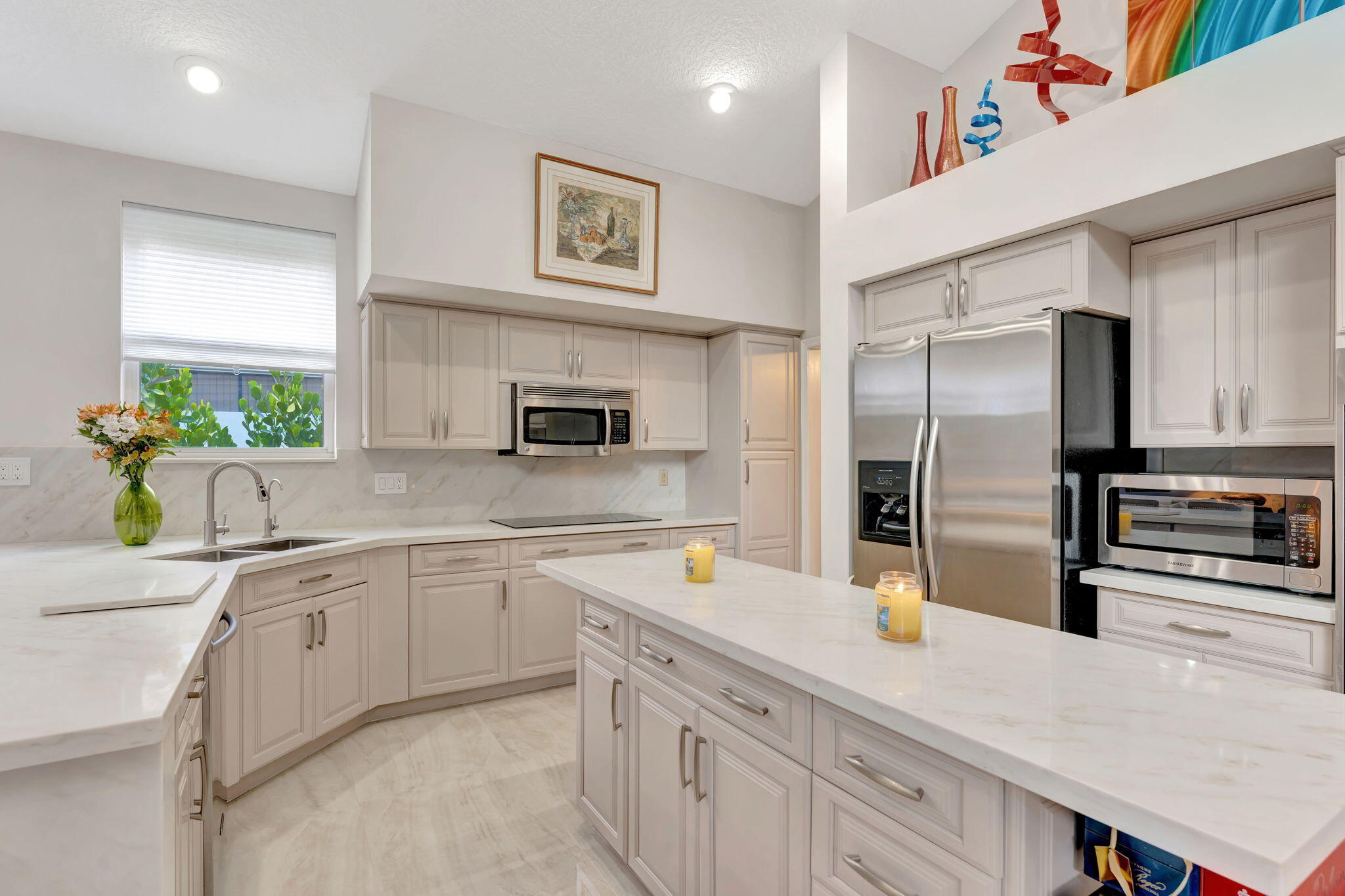6039 Northwest 31st Terrace Boca Raton, FL 33496 - Photo 23 of 70 a kitchen with a sink stainless steel appliances and white cabinets