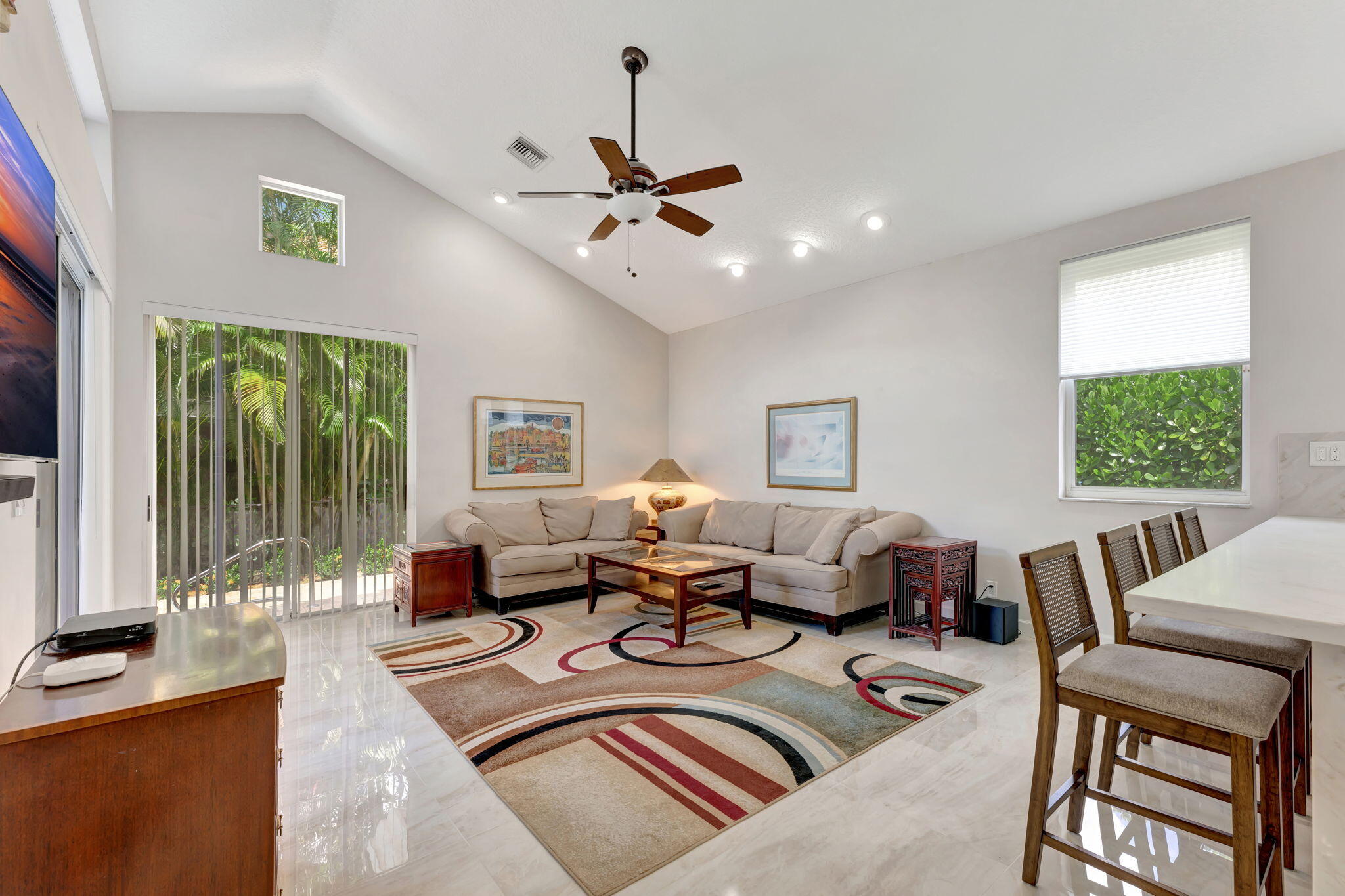 6039 Northwest 31st Terrace Boca Raton, FL 33496 - Photo 26 of 70 a living room with furniture two window and a flat screen tv