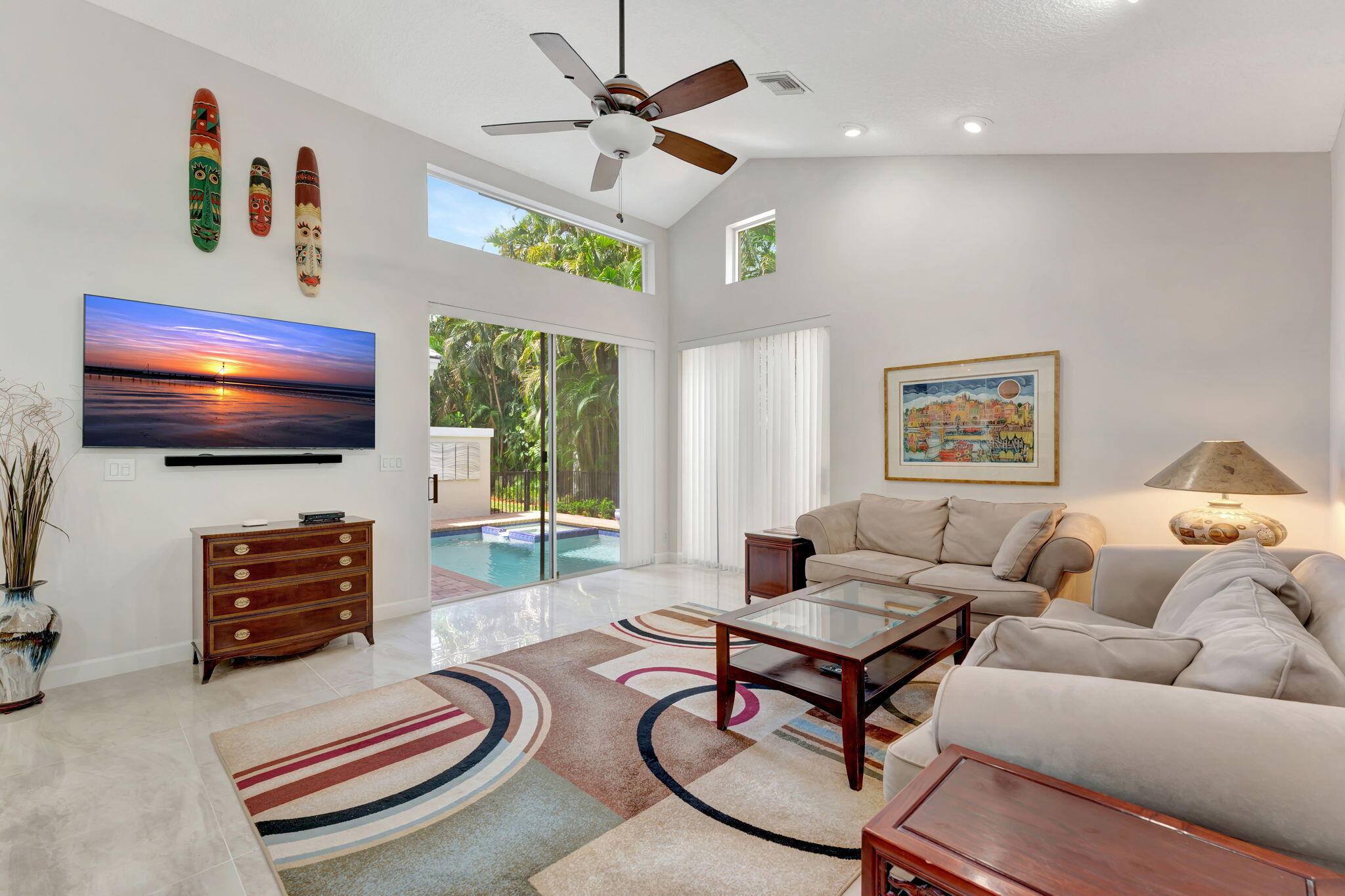6039 Northwest 31st Terrace Boca Raton, FL 33496 - Photo 27 of 70 a living room with furniture a flat screen tv and a large window