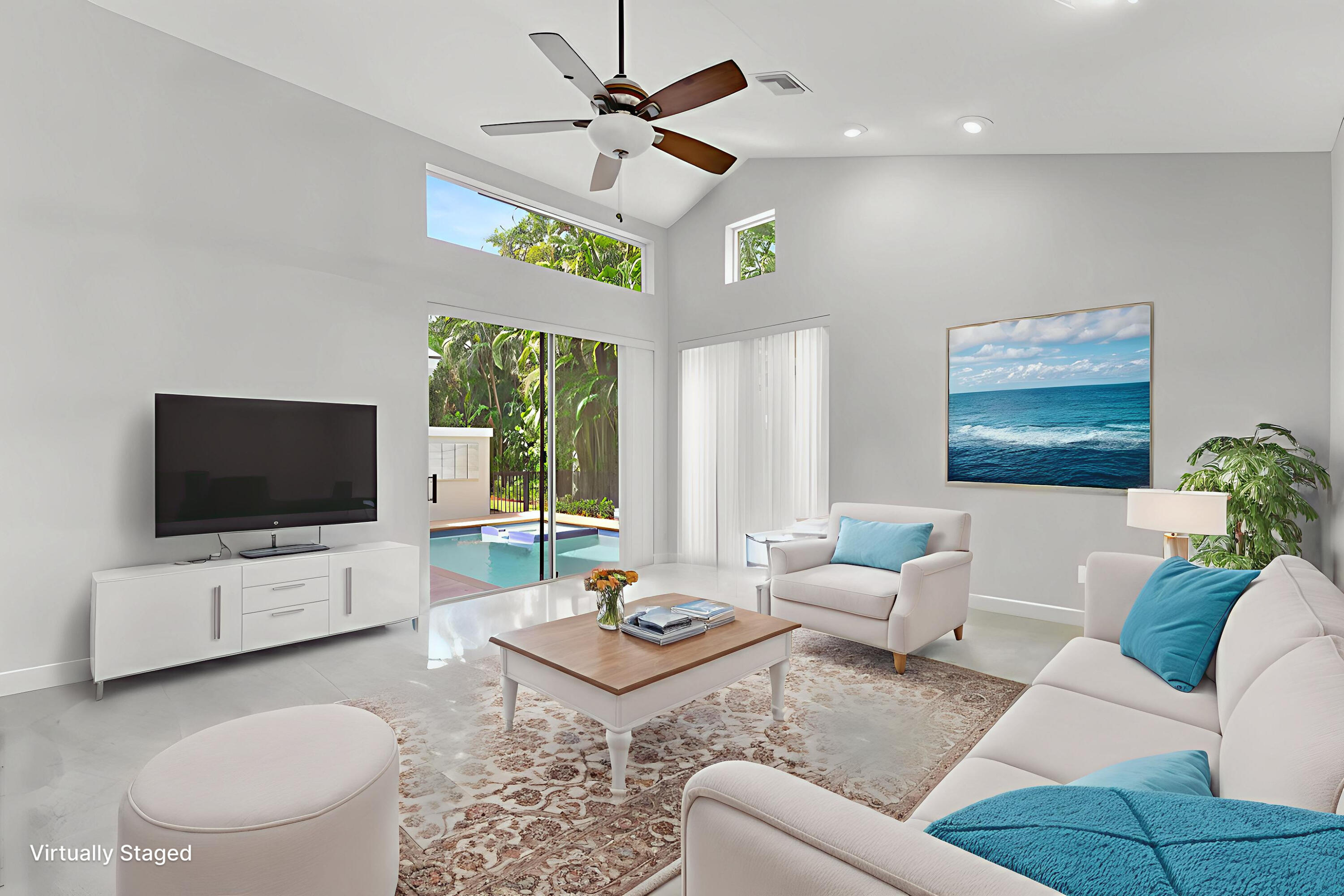 6039 Northwest 31st Terrace Boca Raton, FL 33496 - Photo 28 of 70 a living room with furniture a flat screen tv and a large window