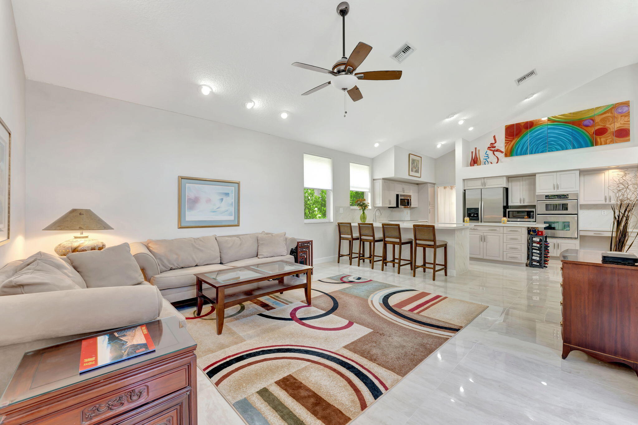 6039 Northwest 31st Terrace Boca Raton, FL 33496 - Photo 29 of 70 a living room with furniture and kitchen view