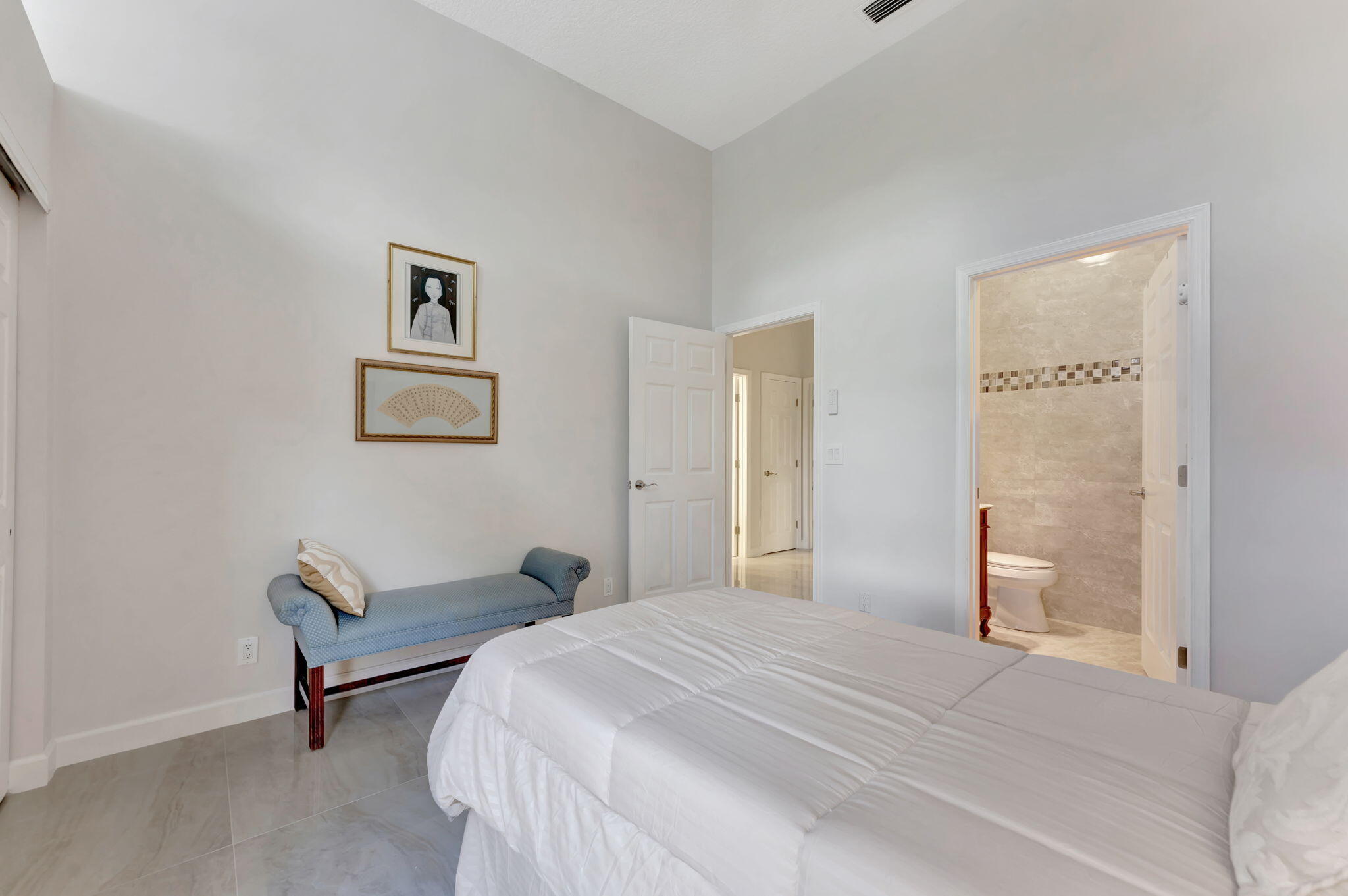 6039 Northwest 31st Terrace Boca Raton, FL 33496 - Photo 31 of 70 a bedroom with a bed and a chair