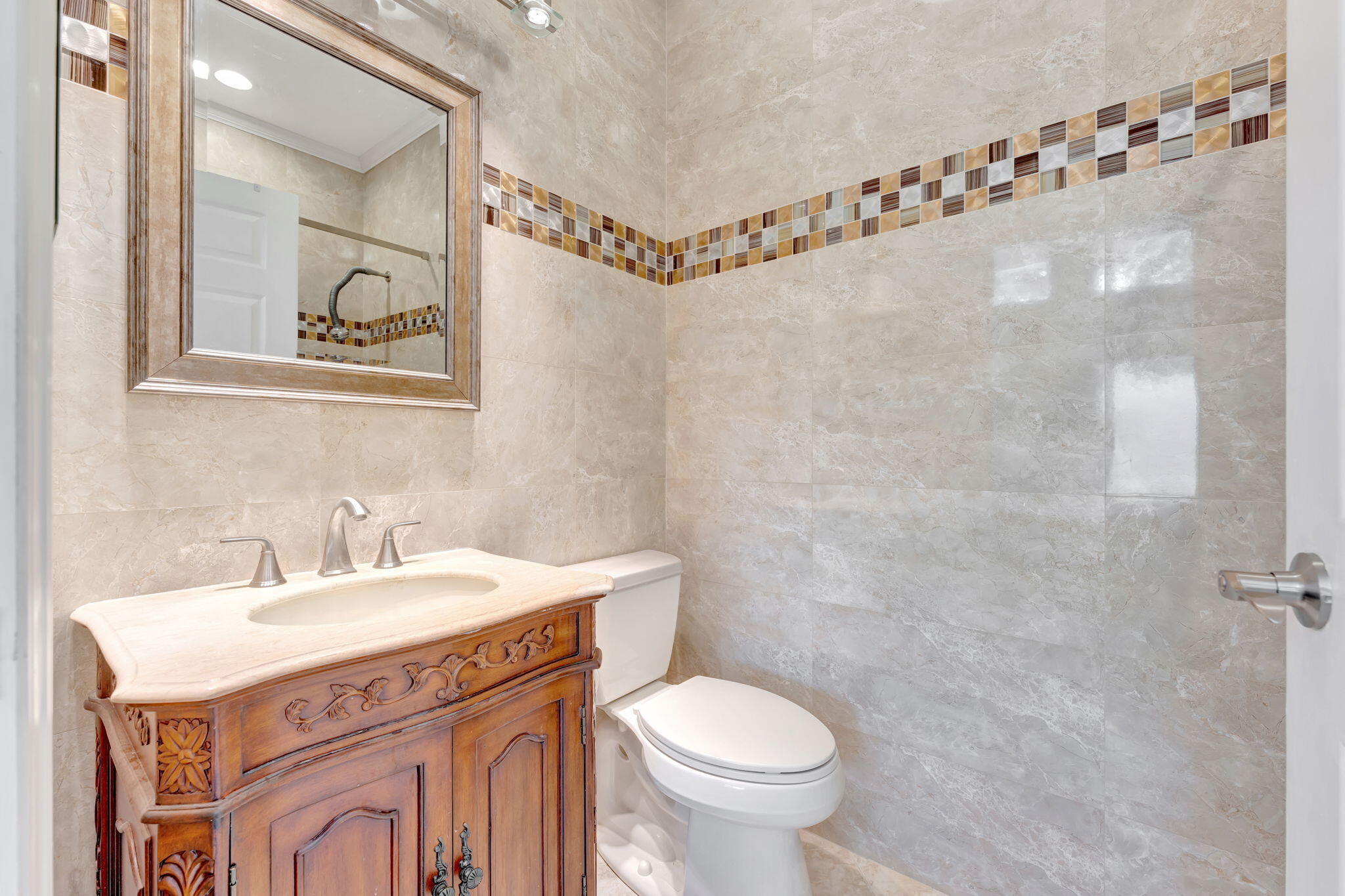 6039 Northwest 31st Terrace Boca Raton, FL 33496 - Photo 32 of 70 a bathroom with a sink mirror vanity and toilet