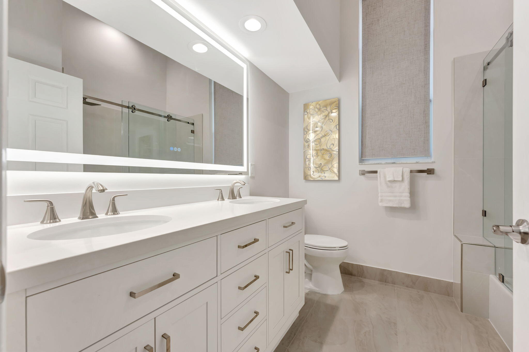 6039 Northwest 31st Terrace Boca Raton, FL 33496 - Photo 36 of 70 a bathroom with a double vanity sink toilet and a mirror