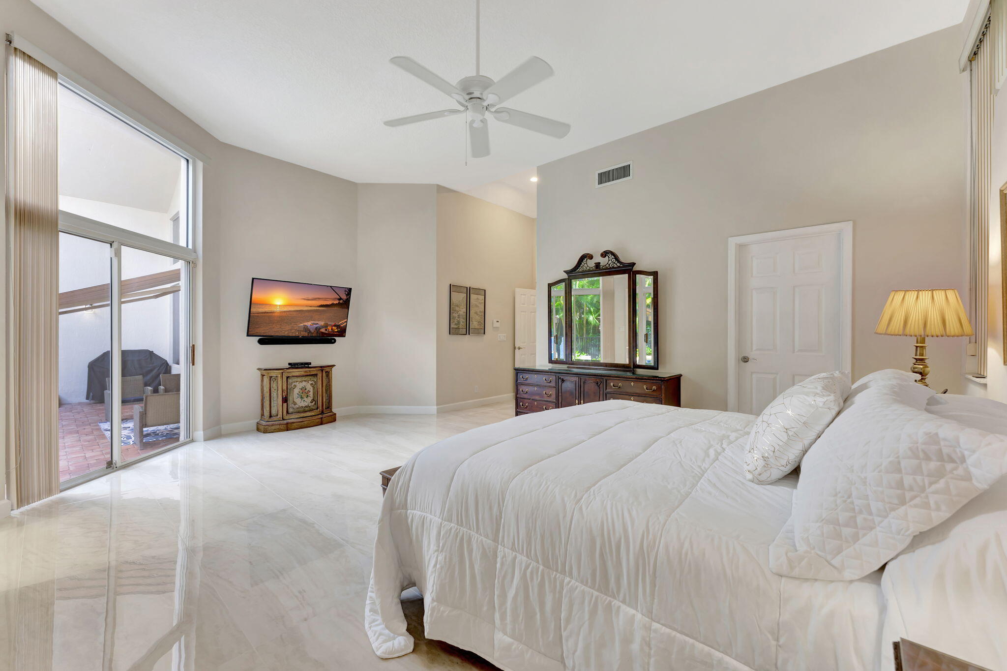 6039 Northwest 31st Terrace Boca Raton, FL 33496 - Photo 45 of 70 a bedroom with a bed and a flat screen tv