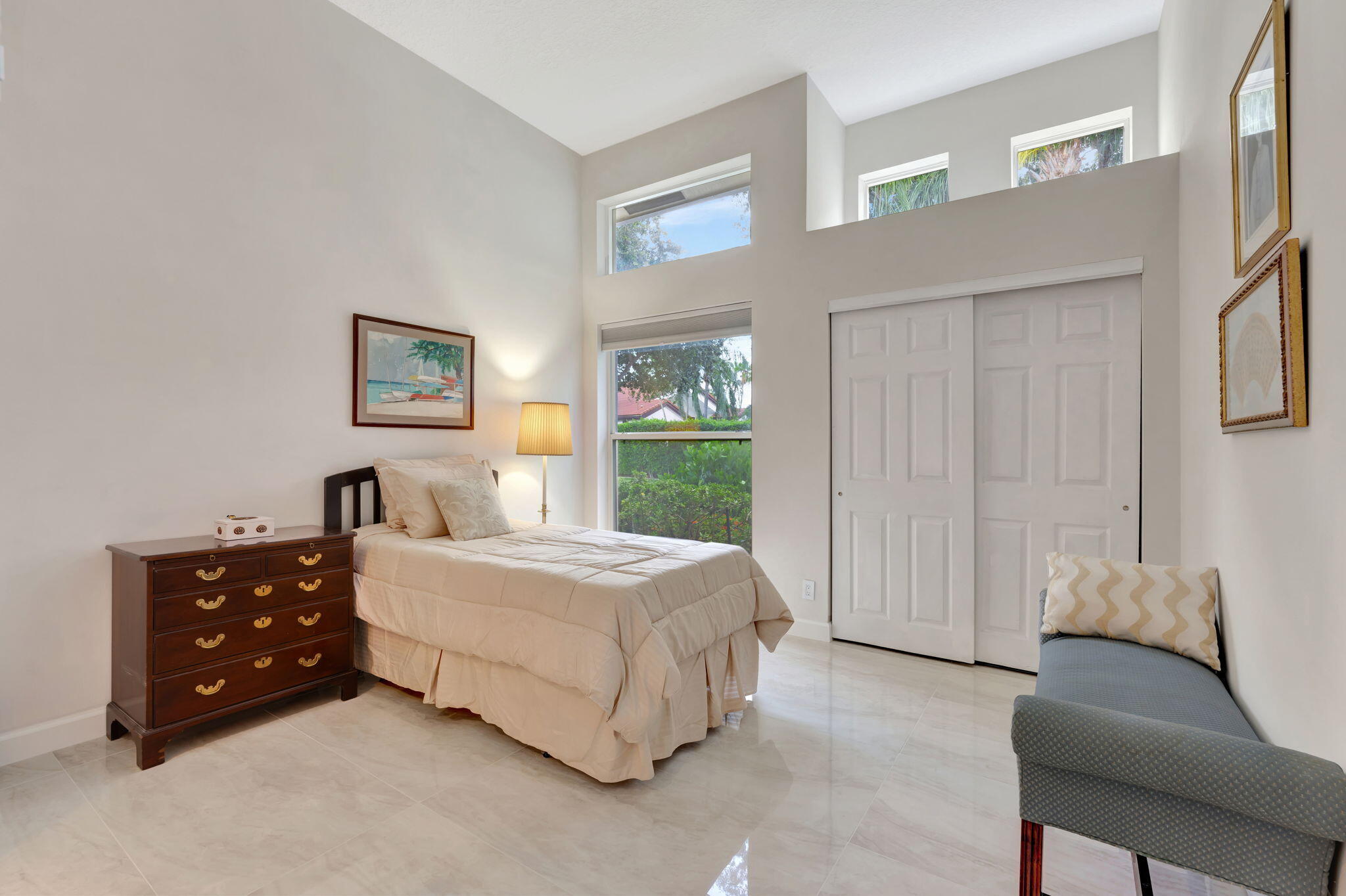 6039 Northwest 31st Terrace Boca Raton, FL 33496 - Photo 51 of 70 a bedroom with a bed and a couch