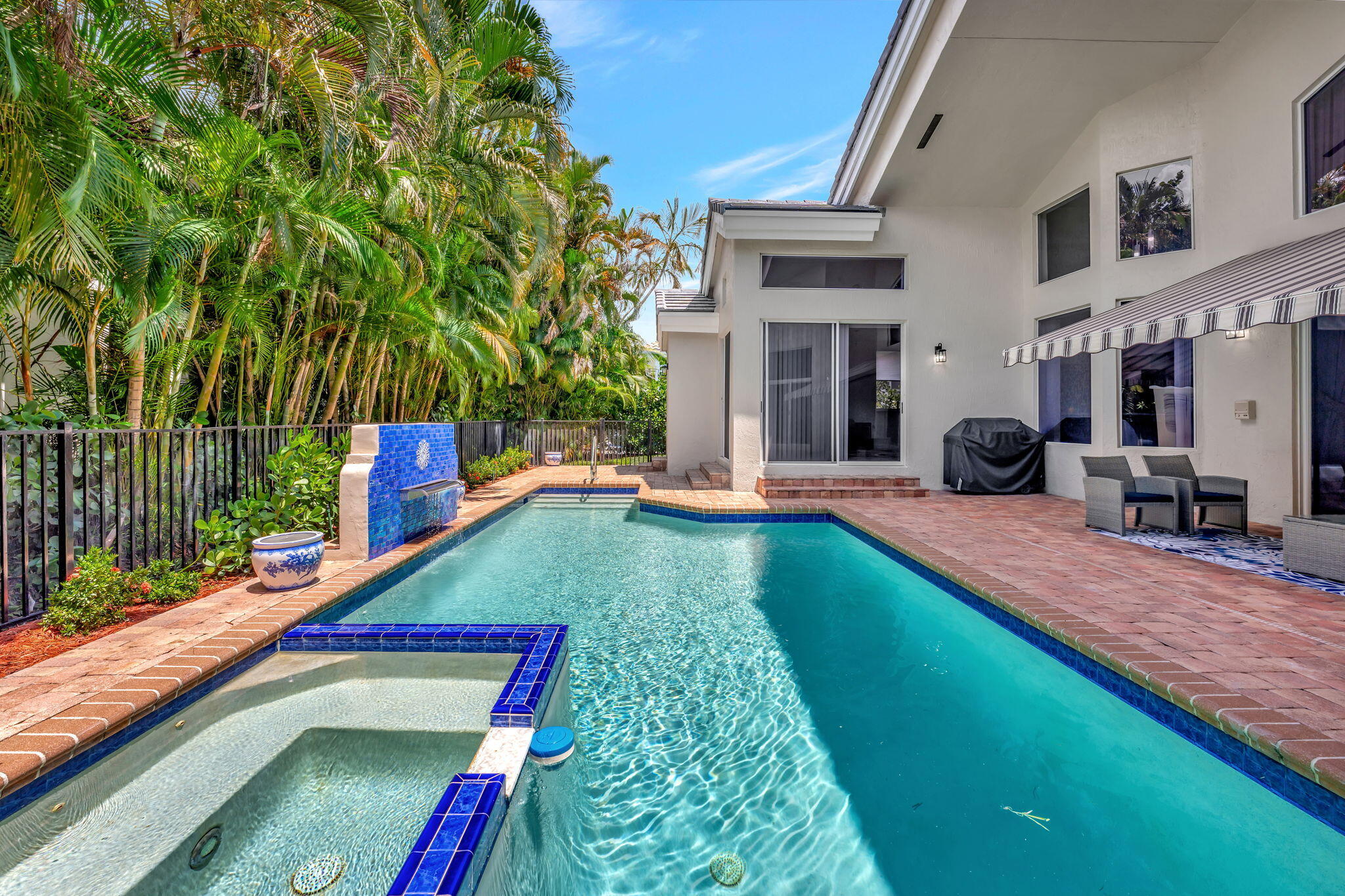 6039 Northwest 31st Terrace Boca Raton, FL 33496 - Photo 59 of 70 a view of an swimming pool with seating area